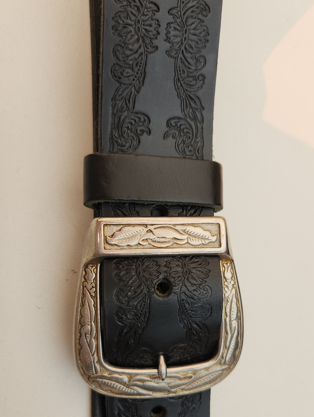 Classic Black Embossed Leather Belt with Decorative Silver-Tone Buckle